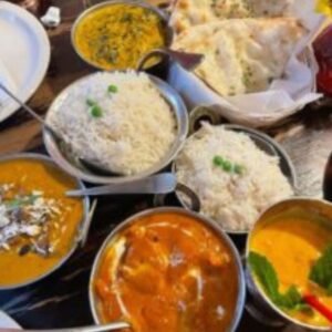 "Traditional Indian thaali with rice, curry, roti, and vegetables"